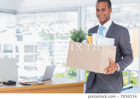 Smiling businessman leaving his company 7656554
