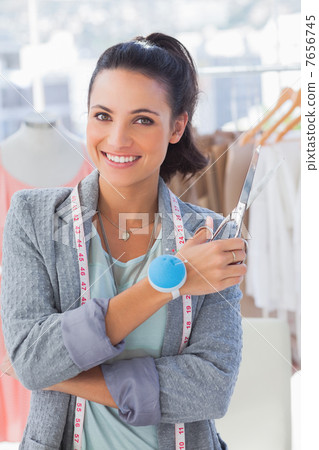 Attractive designer with measuring tape holding scissors 7656745