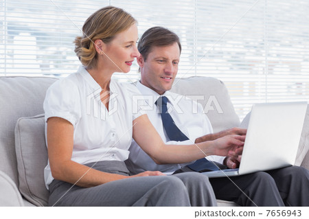 Business people watching something on laptop Business people watching something on laptop 7656943
