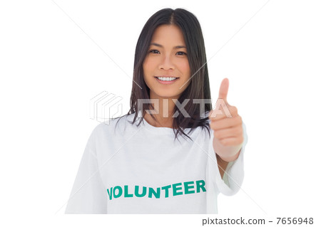 Pretty volunteer woman with thumb up 7656948