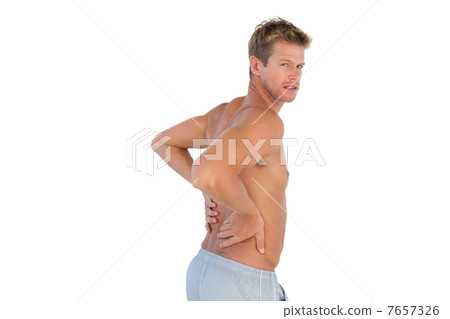 Shirtless handsome man suffering from back pain 7657326