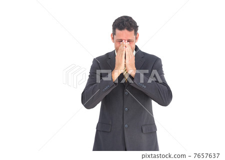 Troubled businessman with hands on his face 7657637