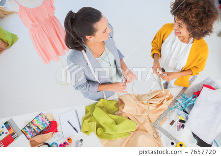Attractive fashion designers working with textile Attractive fashion designers working with textile 7657720