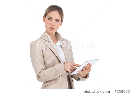 Businesswoman pointing something on her digital tablet Businesswoman pointing something on her digital tablet 7658023