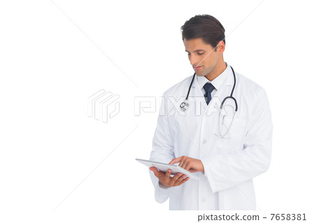 Smiling doctor using a tablet Smiling doctor using a tablet 7658381