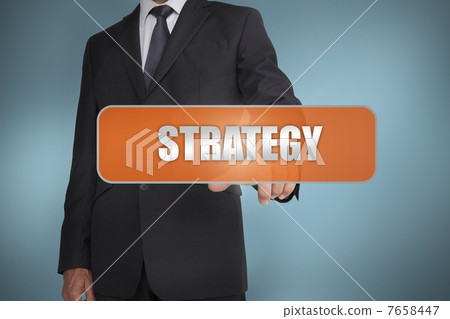 Businessman selecting the word strategy written on orange tag Businessman selecting the word strategy written on orange tag 7658447