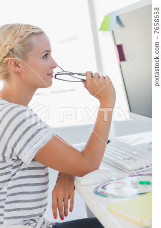 Blonde photo editor at her desk Blonde photo editor at her desk 7658658