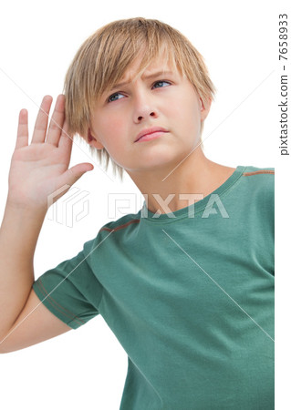 Little boy listening to something 7658933