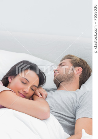 Pretty woman sleeping on her husbands chest 7659036