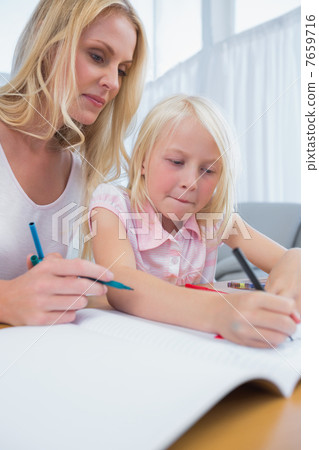 Smiling mother and daughter drawing together 7659716