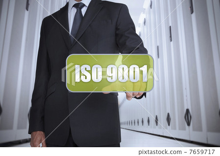 Businessman selecting a green label with iso 9001 Businessman selecting a green label with iso 9001 7659717