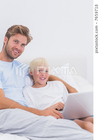 Portrait of a handsome father and his son using a laptop 7659718