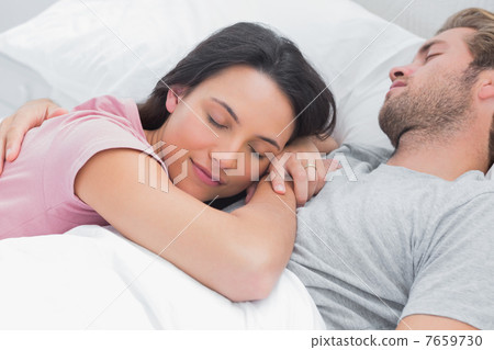 Woman sleeping on her husbands chest Woman sleeping on her husbands chest 7659730