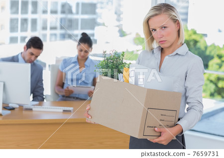 Upset businesswoman leaving office after being let go Upset businesswoman leaving office after being let go 7659731