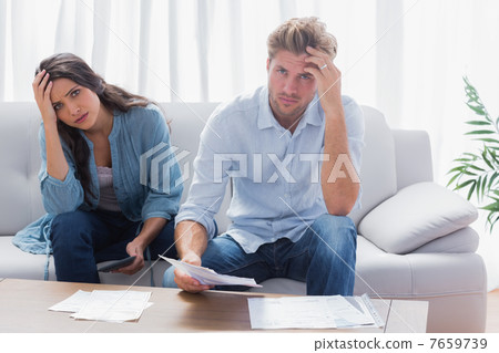 Stressed couple doing their accounts 7659739