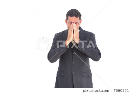 Apprehensive businessman looking at the camera 7660331