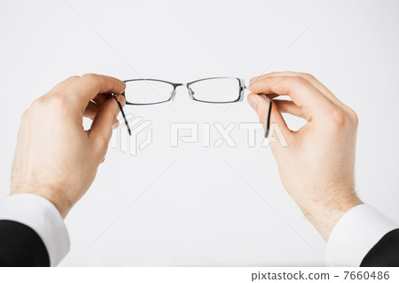 man hands holding eyeglasses 7660486