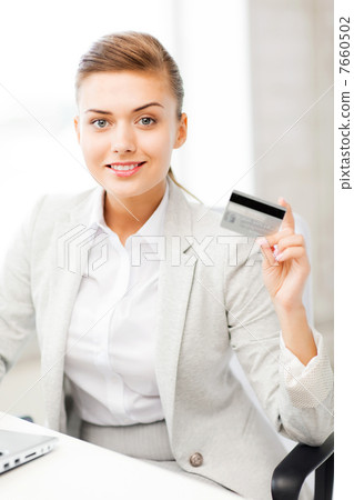 businesswoman with laptop showing credit card 7660502