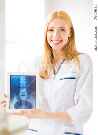 female doctor with x-ray on tablet pc 7660653