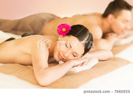 couple in spa with hot stones couple in spa with hot stones 7660850