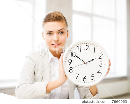 attractive businesswoman showing white clock 7660963