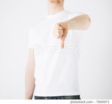 man showing thumbs down man showing thumbs down 7660971