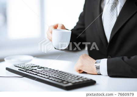 man hands with keyboard drinking coffee 7660979