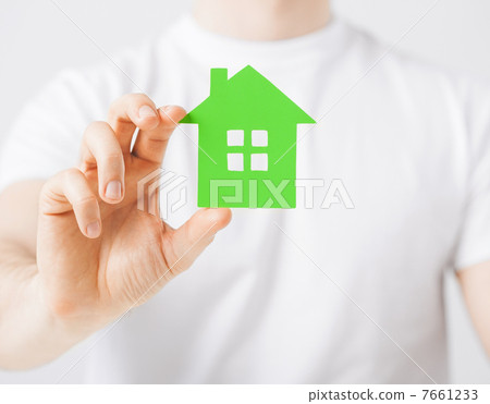 hand holding green house 7661233