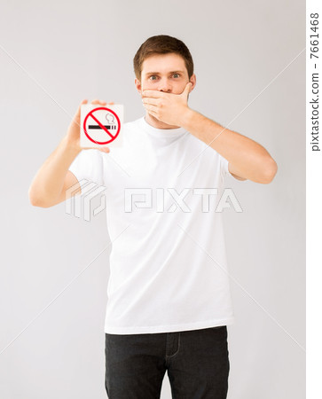 young man holding no smoking sign 7661468