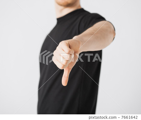 man showing thumbs down man showing thumbs down 7661642