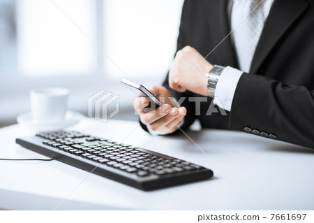 man hands with keyboard, smartphone and wristwatch 7661697
