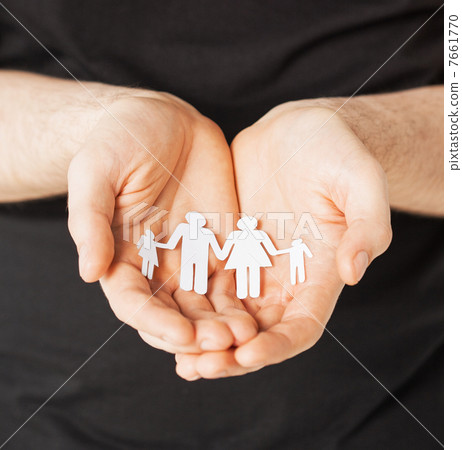 man hands with paper men 7661770