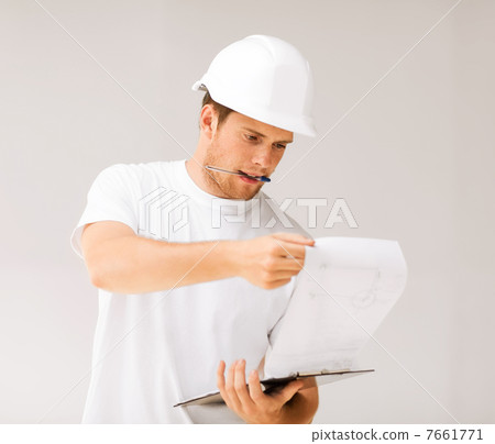 male architect looking at blueprint male architect looking at blueprint 7661771