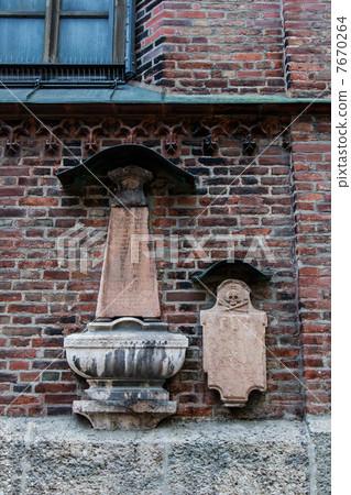 A tombstone decorated on the outer wall of the Frauenkirche church in Munich A tombstone decorated on the outer wall of the Frauenkirche church in Munich 7670264