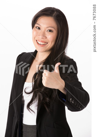 Pleased Asian woman with thumb up. Pleased Asian woman with thumb up. 7673088