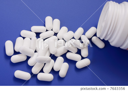 Spilled tablets and medicine bottle.  7683356