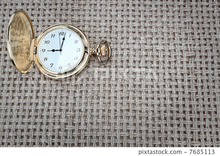 Antique pocket watch on a textured burlap. Close-up. Antique pocket watch on a textured burlap. Close-up. 7685113