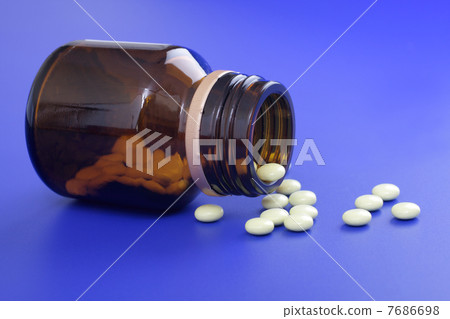 Spilled tablets and medicine bottle. Spilled tablets and medicine bottle. 7686698