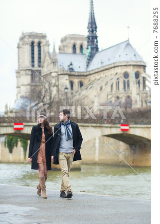Couple walking near the Notre-Dame in Paris Couple walking near the Notre-Dame in Paris 7688255