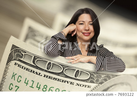 Hispanic Woman Leaning on a One Hundred Dollar Bill 7693122