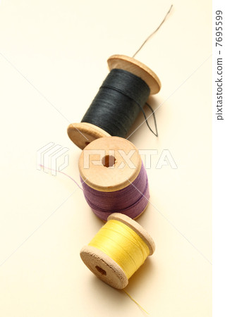 Three thread bobbins in closeup Three thread bobbins in closeup 7695599