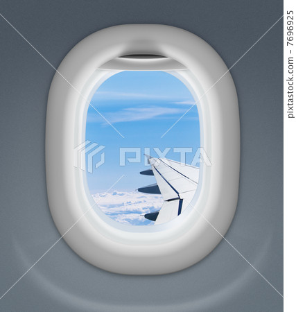 airplane window with wing and cloudy sky behind 7696925