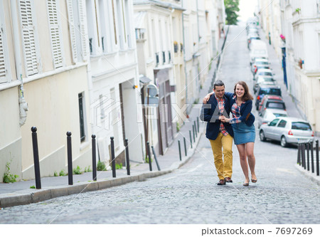 Happy couple walking together in Paris Happy couple walking together in Paris 7697269