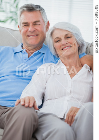 Couple relaxing together on a couch 7699309