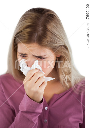 Portrait of woman blowing her nose 7699400