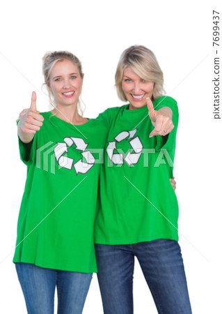 Two women wearing green recycling tshirts giving thumbs up Two women wearing green recycling tshirts giving thumbs up 7699437