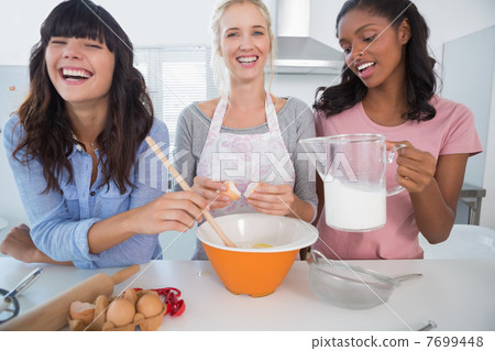 Laughing friends making pastry together Laughing friends making pastry together 7699448