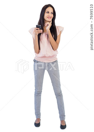 Woman thinking about text message Woman thinking about text message 7699510