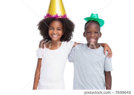 Brother and sister wearing party hats Brother and sister wearing party hats 7699648