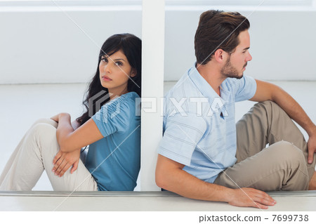 Sitting couple are separated by wall Sitting couple are separated by wall 7699738